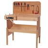 Wooden back wall mounted on children's wooden carpenter's workbench, decorated with several tools.