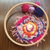 The result of my 5-year-old granddaughter's weaving on the round loom.