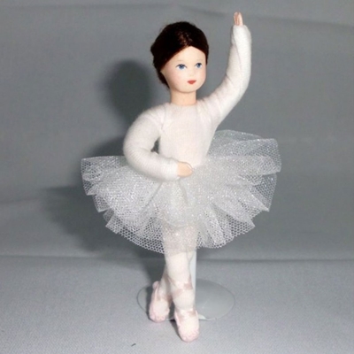 An Erna Meyer flexible doll ballerina with white tutu and pale pink ballet shoes is standing in dancing position.